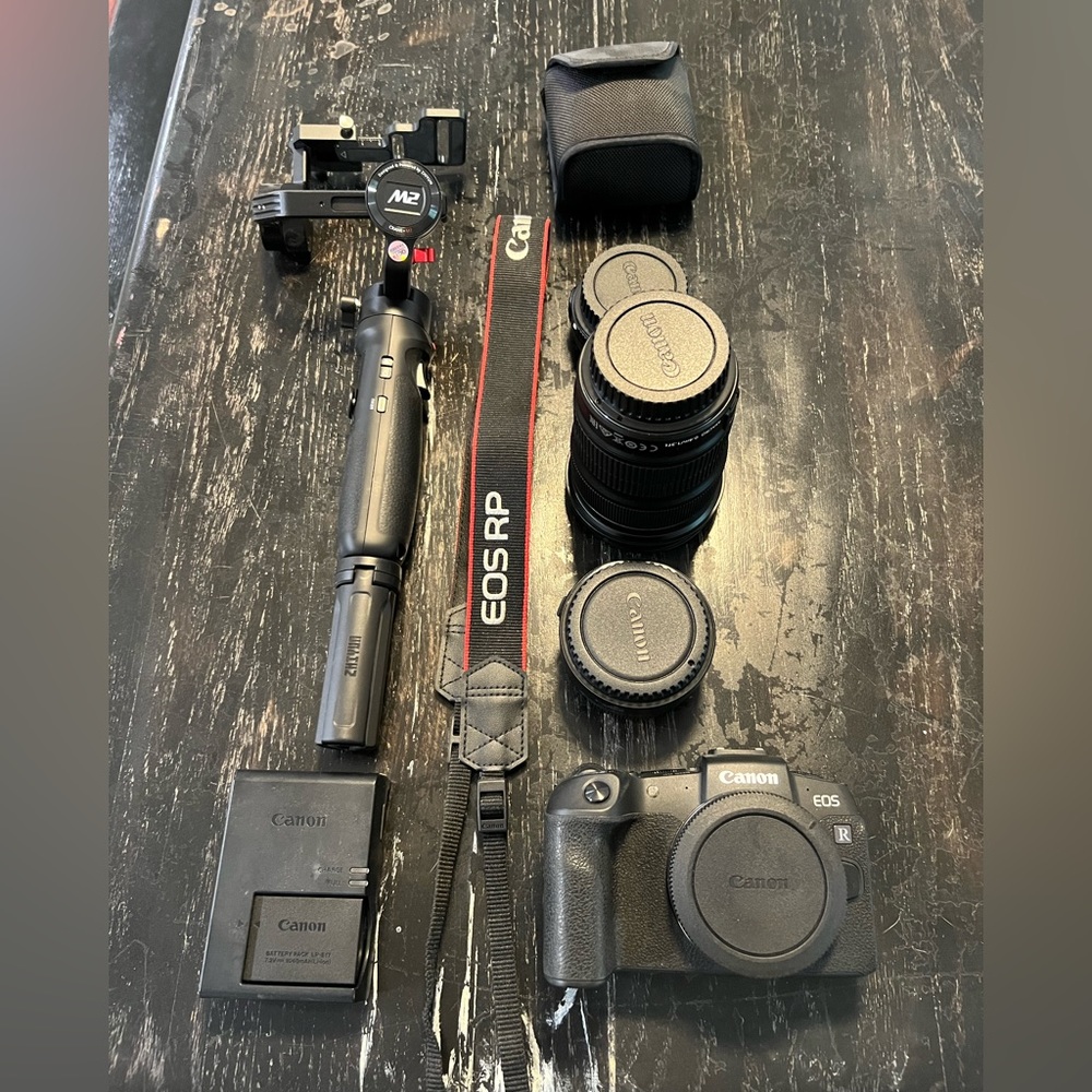 Canon EOS RP with mount adapter, two lenses, gimbal, and strap